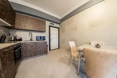 a kitchen with a table and chairs in a room at Sofia Industrial Life Apartment in Sofia