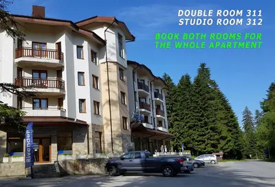 a truck parked in front of a building at Villa Park Studio&Double room in Borovets