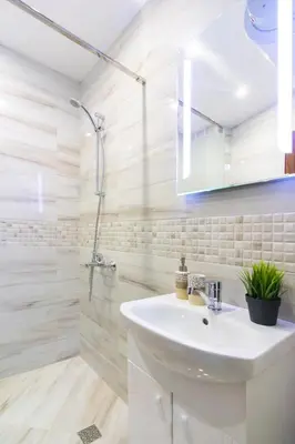 a bathroom with a sink and a shower at Domus Apartments Grand with Parking in Plovdiv