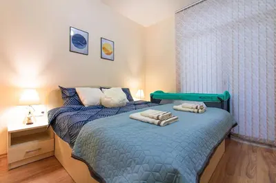 a bedroom with a bed with towels on it at Domus Apartments Grand with Parking in Plovdiv