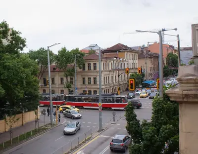a busy city street with cars and a bus at Cozy apartment in the historical center of Sofia in Sofia