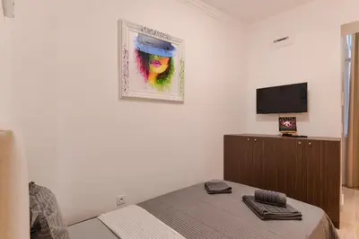 a bedroom with a bed and a flat screen tv at CACAO Studio next to Crystal Garden and Russian Church by Flat Mаnager in Sofia