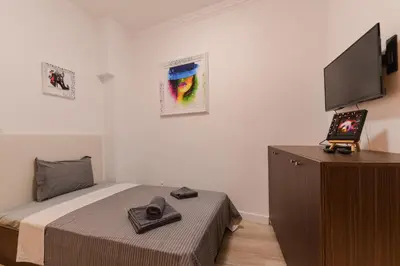 a bedroom with a bed and a flat screen tv at CACAO Studio next to Crystal Garden and Russian Church by Flat Mаnager in Sofia