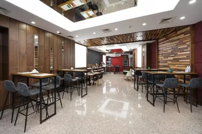 a restaurant with wooden walls and tables and chairs at B1 Boutique Hotel Sofia in Sofia