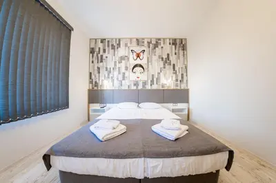 a bedroom with a bed with towels on it at Sofia Downtown Life Apartment in Sofia