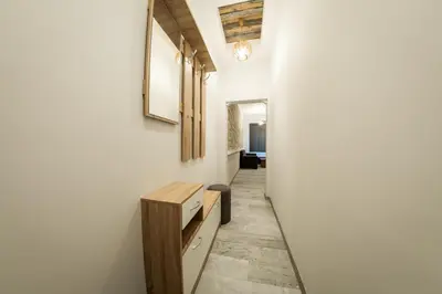 a hallway with a table and a bench in a room at Sofia Downtown Life Apartment in Sofia