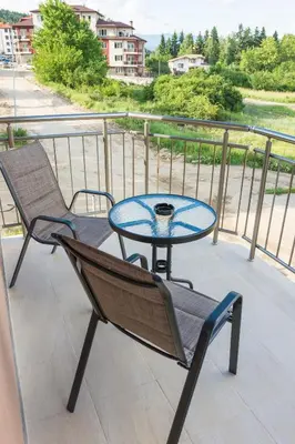 a patio with a table and chairs on a balcony at Apartment Petya in Velingrad