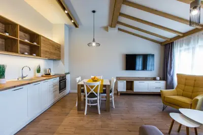 a kitchen and living room with a table and chairs at HillHouse Plovdiv in Plovdiv