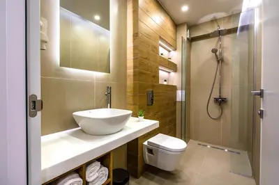 a bathroom with a sink and a toilet and a shower at HillHouse Plovdiv in Plovdiv