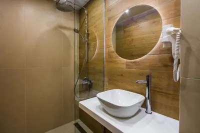 a bathroom with a sink and a mirror at HillHouse Plovdiv in Plovdiv