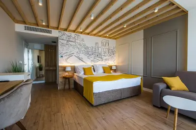 a hotel room with a bed and a couch at HillHouse Plovdiv in Plovdiv