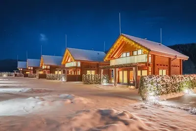 a lodge with snow on the ground in front of it at Samovilla in Govedartsi