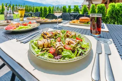 a table with a salad and a plate of food at Samovilla in Govedartsi