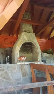 a stone oven with a dog inside of it at Вила Керенски in Ribarica