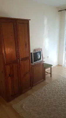 a living room with a tv sitting on a cabinet at Вила Керенски in Ribarica