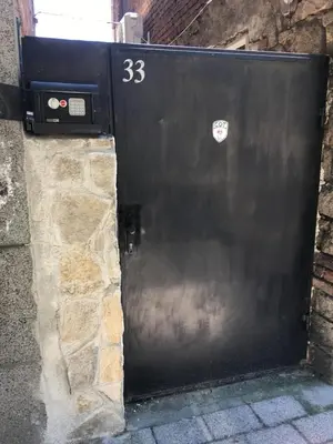 a black garage door with a sticker on it at Нощувки Пловдив Тепето Plovdiv Hill in Plovdiv