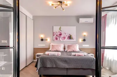 a bedroom with a large bed with pink pillows at ROSÉ one bedroom designer apartment in city centre by Flat Mаnager in Sofia