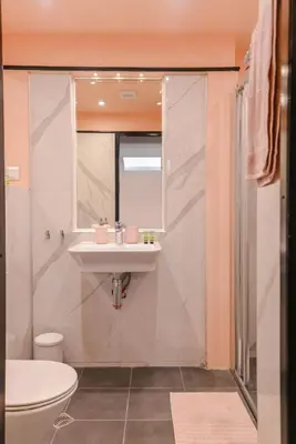 a bathroom with a sink and a toilet at ROSÉ one bedroom designer apartment in city centre by Flat Mаnager in Sofia