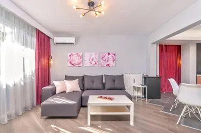 a living room with a couch and a table at ROSÉ one bedroom designer apartment in city centre by Flat Mаnager in Sofia