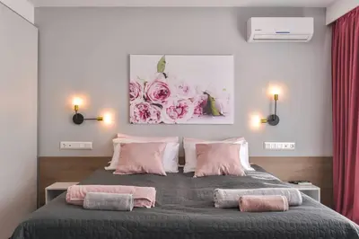 a bedroom with a large bed with pink pillows at ROSÉ one bedroom designer apartment in city centre by Flat Mаnager in Sofia