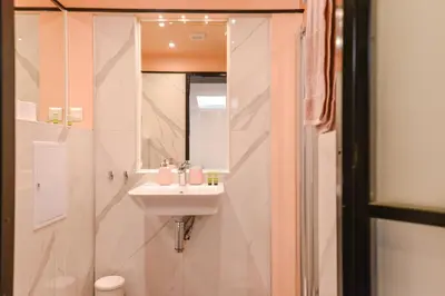 a white bathroom with a sink and a mirror at ROSÉ one bedroom designer apartment in city centre by Flat Mаnager in Sofia