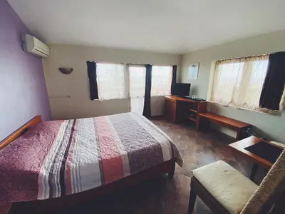 a bedroom with a bed and a chair and a desk at Hotel Fancy in Sofia