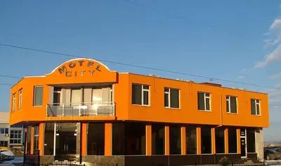 an orange building with a north city sign on it at МОТЕЛ СИТИ с БЕЗПЛАТЕН ПАРКИНГ in Plovdiv