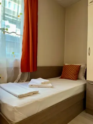 a bed with two towels sitting on top of it at Хостел Атлас - Hostel Atlas in Blagoevgrad