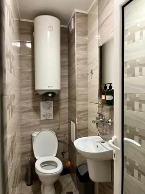 a small bathroom with a toilet and a sink at Хостел Атлас - Hostel Atlas in Blagoevgrad