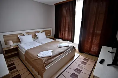 a bedroom with a bed with two towels on it at City Apartments in Velingrad