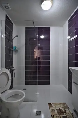 a man taking a picture of a bathroom with a toilet at City Apartments in Velingrad