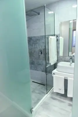 a bathroom with a shower and a toilet and a sink at Стаи за гости Десита in Blagoevgrad