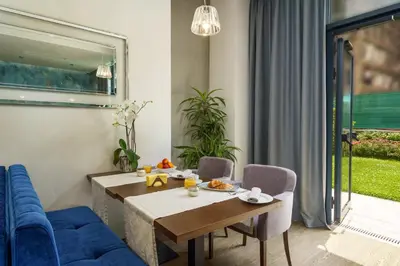 a living room with a table and a blue couch at Impresamente Art Hotel in Sofia