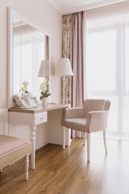 a desk and chair in a room with a window at Impresamente Art Hotel in Sofia