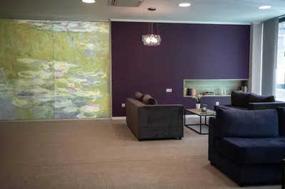 a living room with a large painting on the wall at Impresamente Art Hotel in Sofia