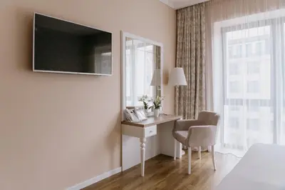 a hotel room with a desk and a window at Impresamente Art Hotel in Sofia