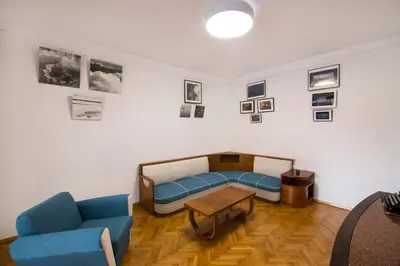 a room with a couch and a table and pictures on the wall at Design Apartment in Sofia top city center in Sofia