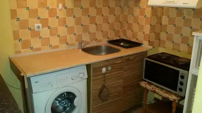 a kitchen with a sink and a washing machine at encanto in Plovdiv