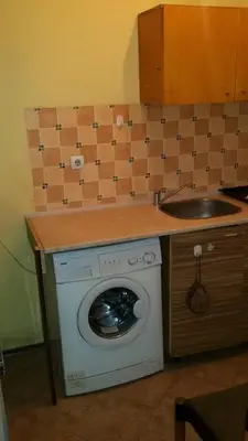 a kitchen with a washing machine and a sink at encanto in Plovdiv