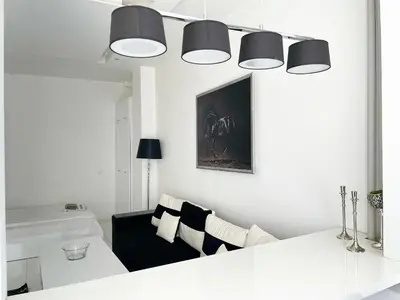 a white living room with a couch and a table at Zero-Waste Studio Apartment in Central Sofia in Sofia