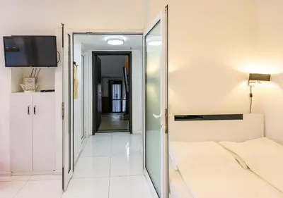 a bedroom with a mirror and a bed and a tv at Zero-Waste Studio Apartment in Central Sofia in Sofia