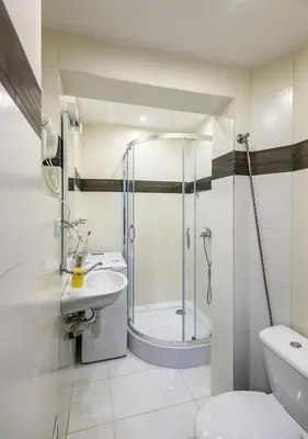 a bathroom with a shower and a toilet and a sink at Zero-Waste Studio Apartment in Central Sofia in Sofia