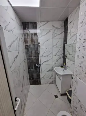 a bathroom with a shower and a toilet and a sink at lux in Plovdiv