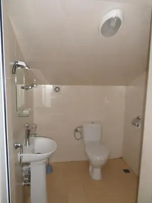 a bathroom with a toilet and a sink at Семеен Хотел 