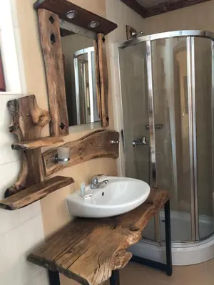 a bathroom with a sink and a shower with a mirror at Pamporovo Villa in Pamporovo