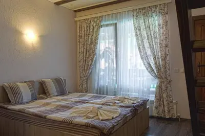 a bedroom with a large bed with a window at СТАР МЕРАК in Ribarica
