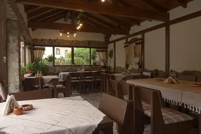 a restaurant with tables and chairs in a room at СТАР МЕРАК in Ribarica