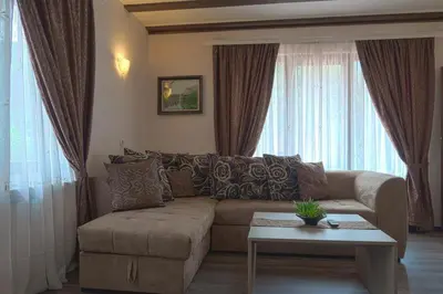 a living room with a couch and a table at СТАР МЕРАК in Ribarica