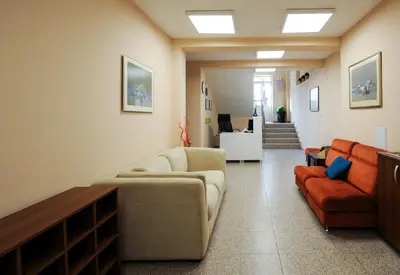a living room with a couch and two chairs at Best Rest Guest Rooms in Plovdiv