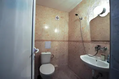 a bathroom with a toilet and a sink at Best Rest Guest Rooms in Plovdiv